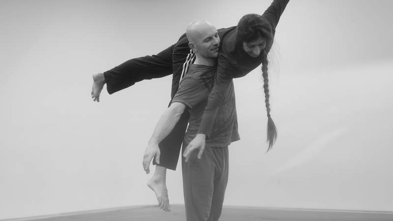 Justin explaining Thai massage techniques to students in a course setting.