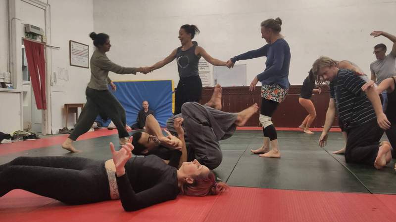 Buddha statue with beautiful light flowers in the foreground, soft focus, black and white.