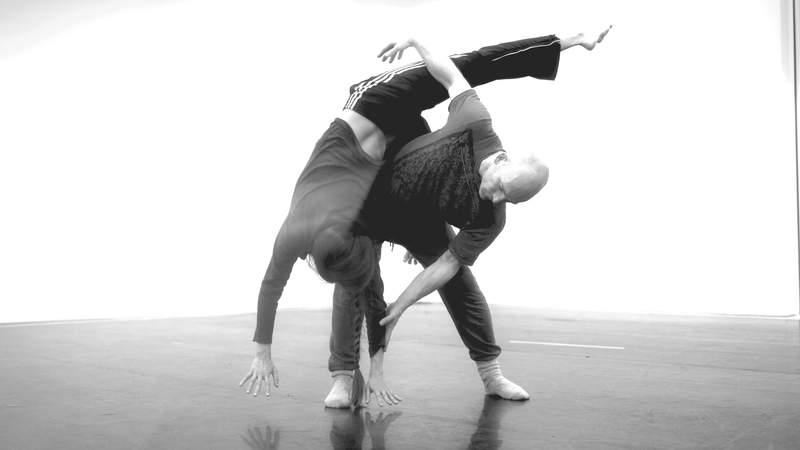 Buddha statue with beautiful light flowers in the foreground, soft focus, black and white.