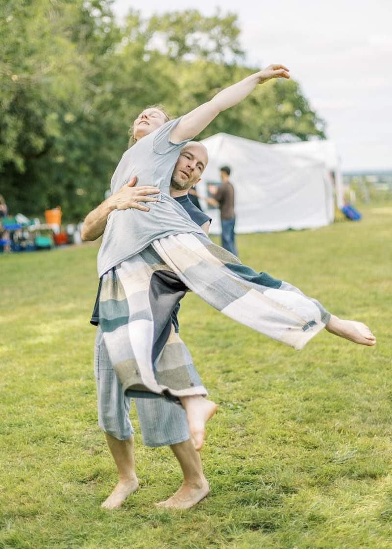 Buddha statue with beautiful light flowers in the foreground, soft focus, black and white.